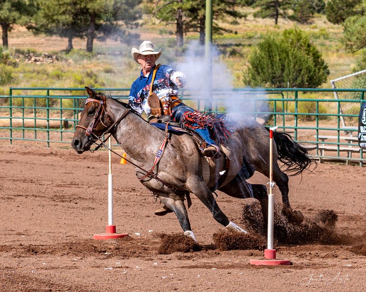 Man riding horse and firing pistol